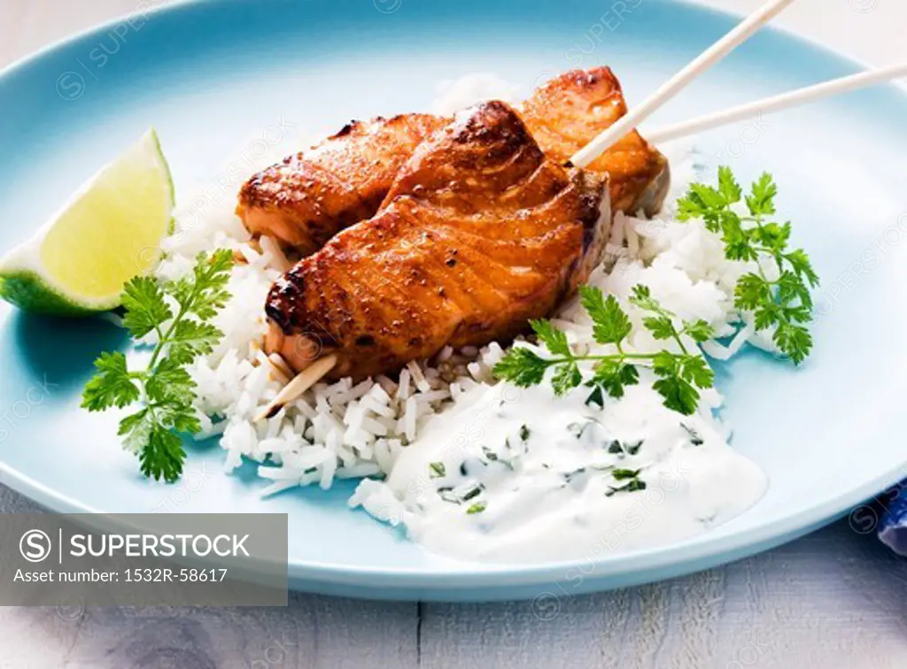Salmon kebab with honey and lime on a bed of rice