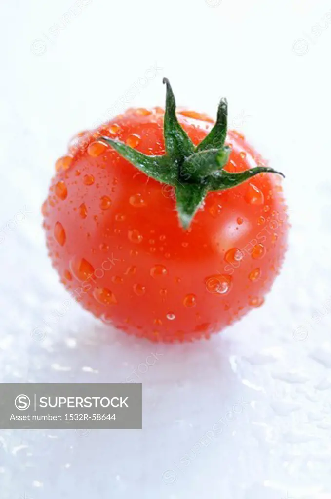 A freshly washed cherry tomato