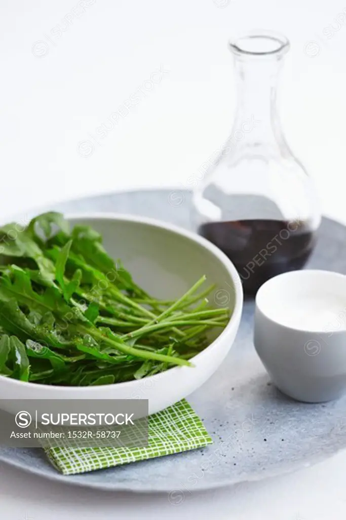 Rocket in a bowl with salad dressing