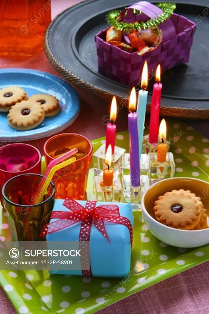 Birthday cakes, candles and jam biscuits
