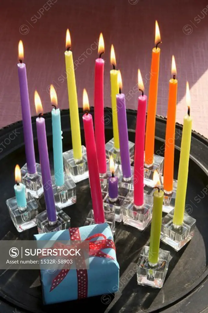 A birthday present and colourful candles