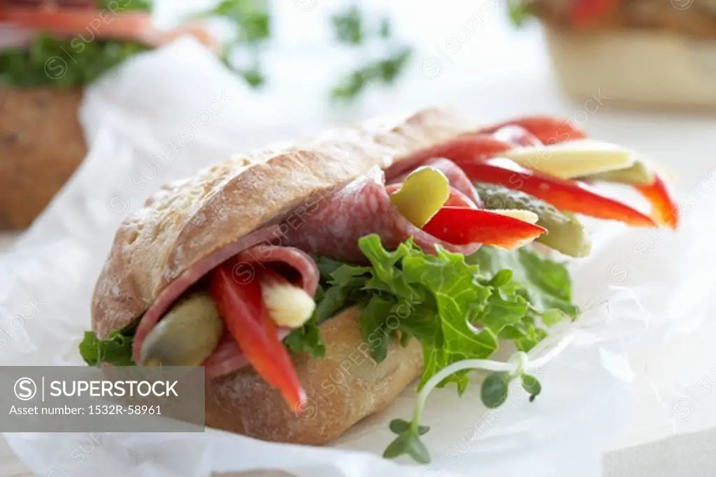 Ciabatta with salami, pepper, gherkins and baby corn cobs