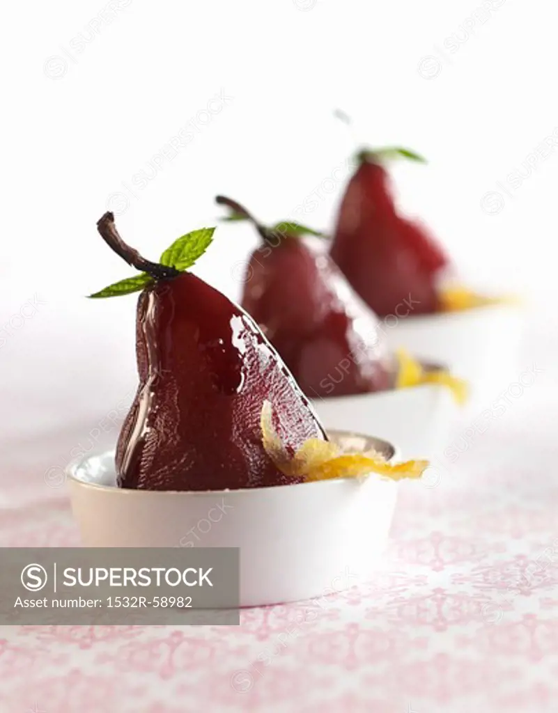 Poached Pears with Candies Orange Peels in White Bowls