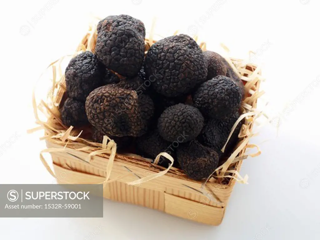 Black truffles in a wooden basket