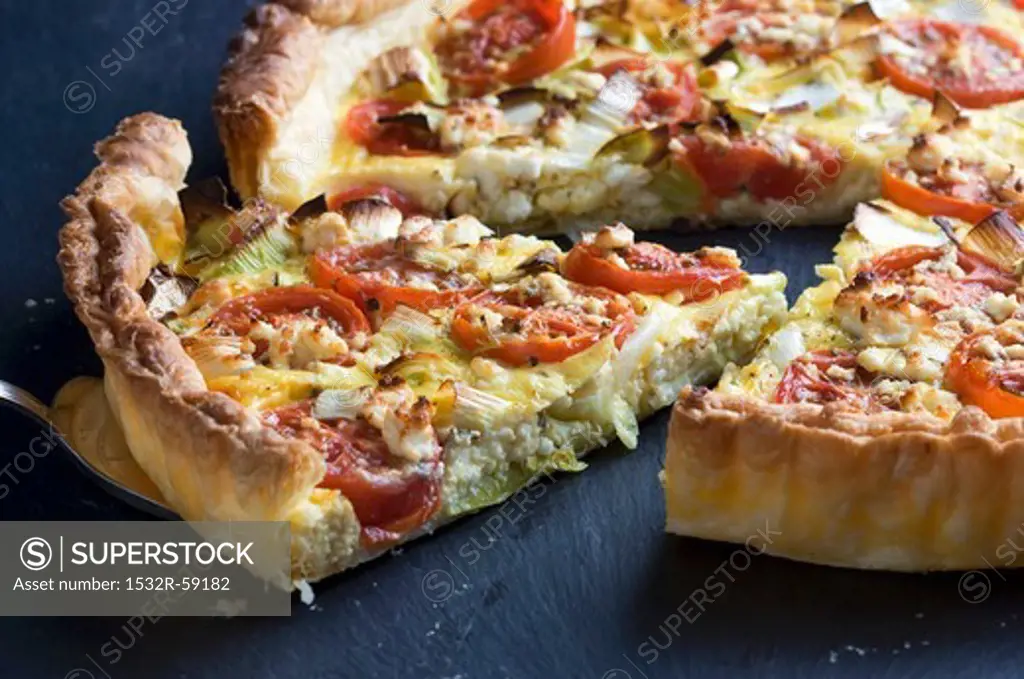 Tomato quiche with leek and feta, sliced