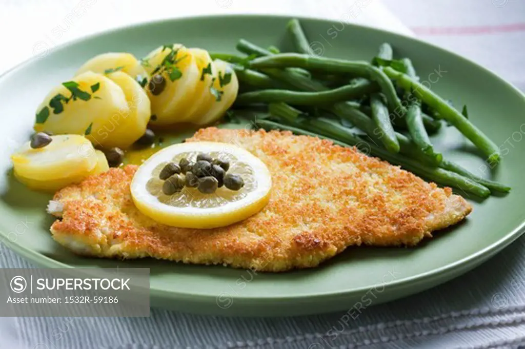 Bread turkey escalope with potatoes, capers and beans