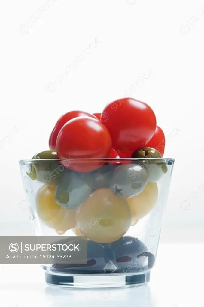 Cherry tomatoes and olives in a glass