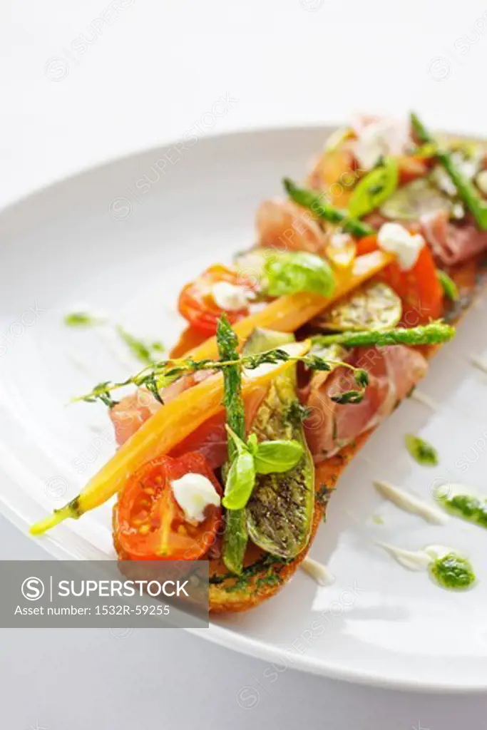 Baguette with ham, grilled vegetables and pesto