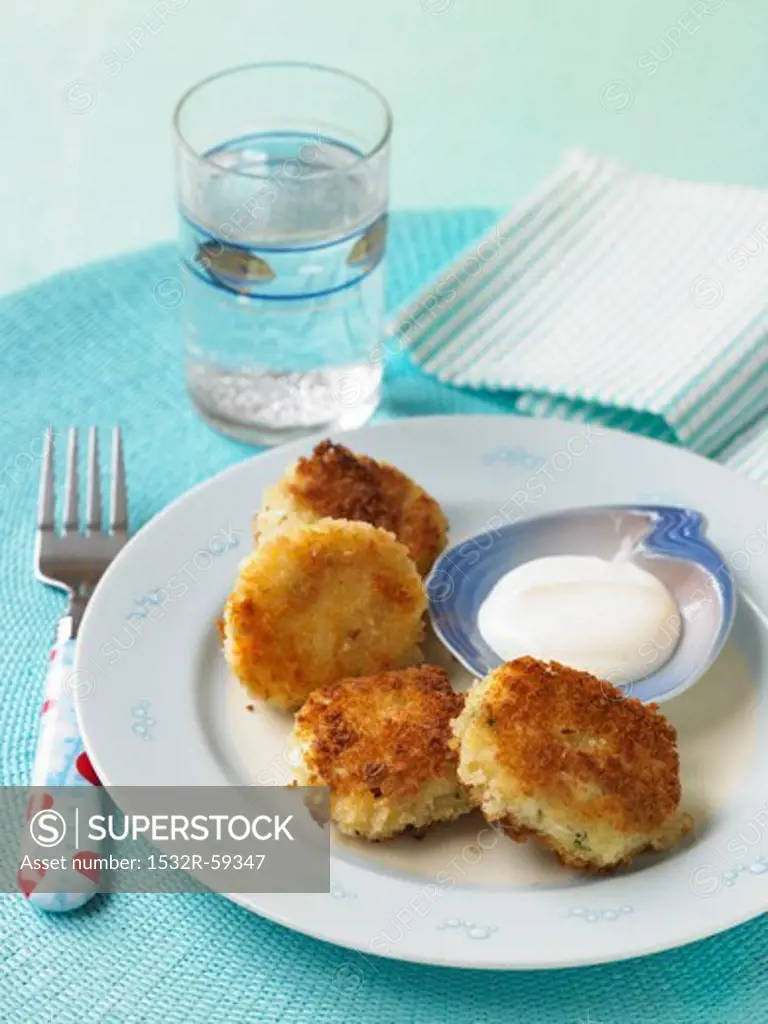 Mini Fish Cakes with Dipping Sauce; Fork and Glass of Water