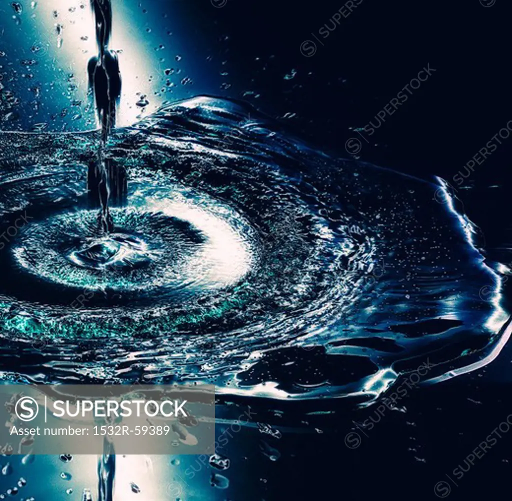 A stream of water hitting the surface of the water