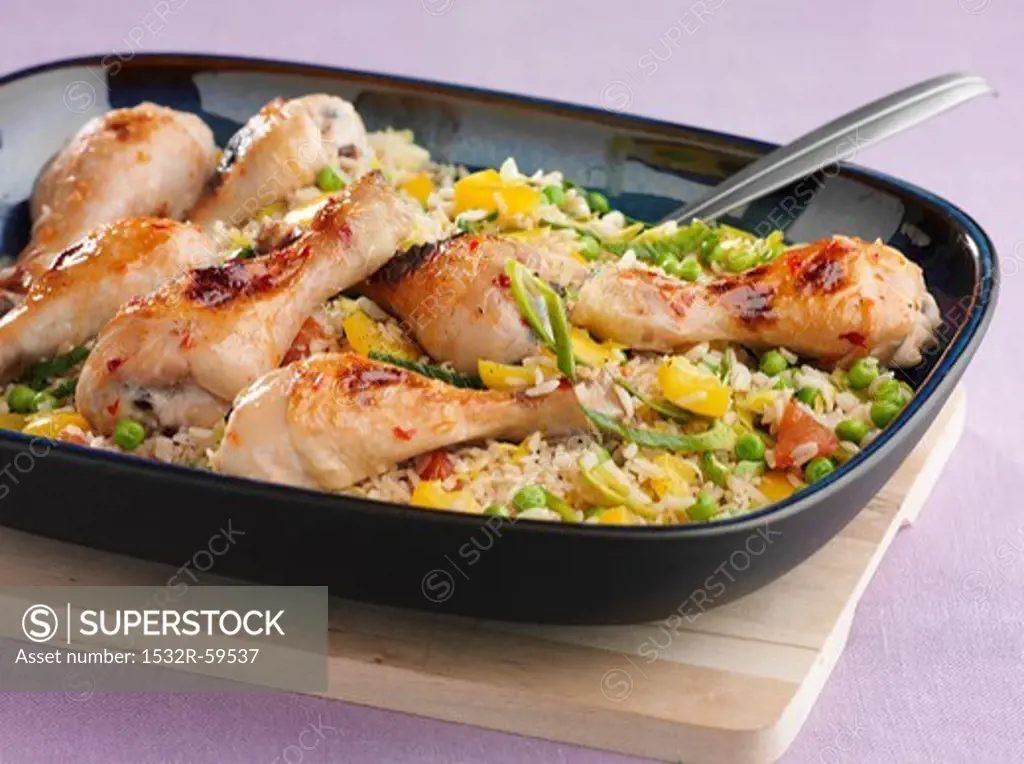 Chicken drumsticks on a bed of vegetable rice