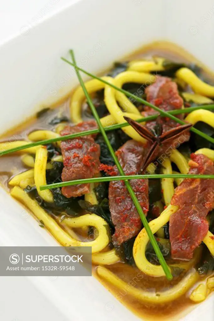 Beef with Japanese mountain pepper, udon noodles and seaweed in vegetable soup
