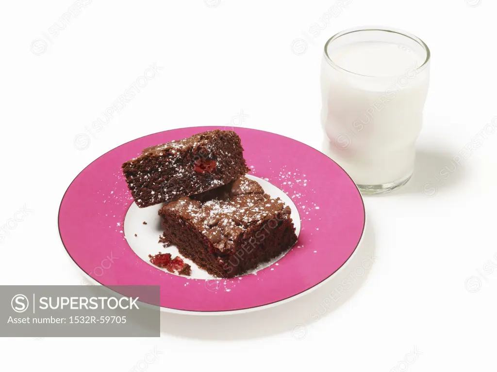Two Cherry Chocolate Brownies with a Glass of Milk