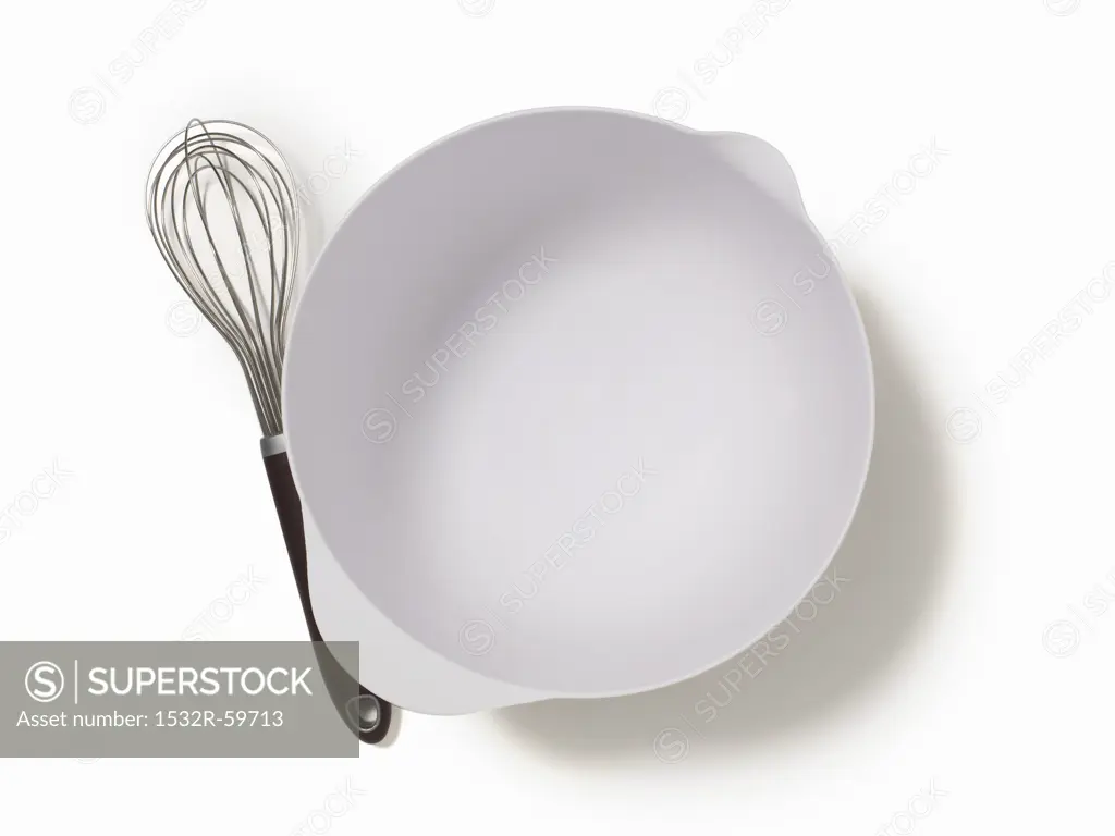 An Empty Mixing Bowl and a Whisk; From Above; White Background