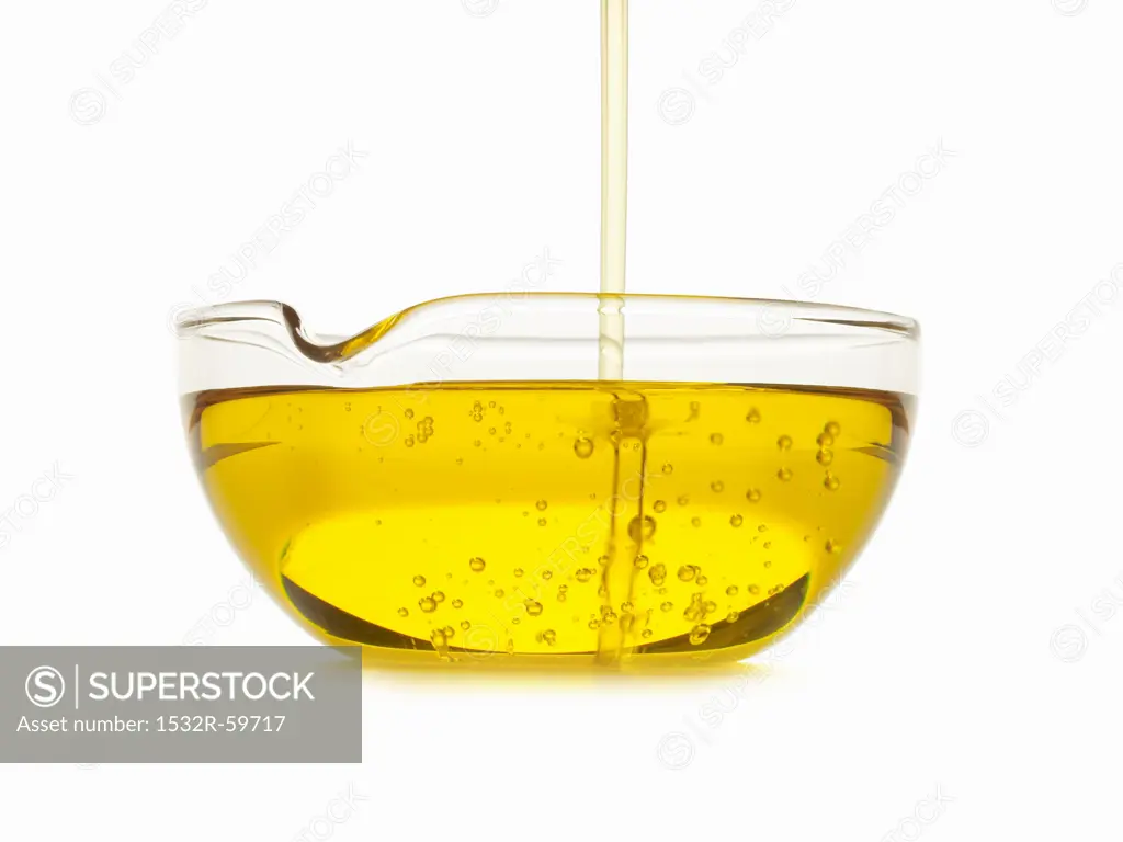 Oil Pouring into a Bowl