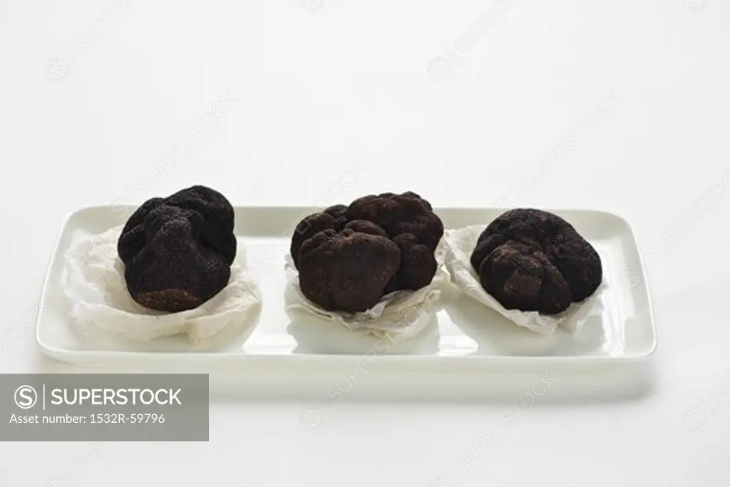 Three Perigord truffles on paper