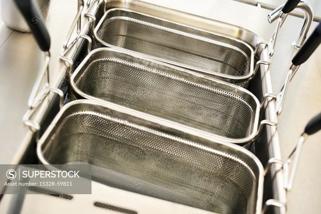 Deep fryers being cleaned with water