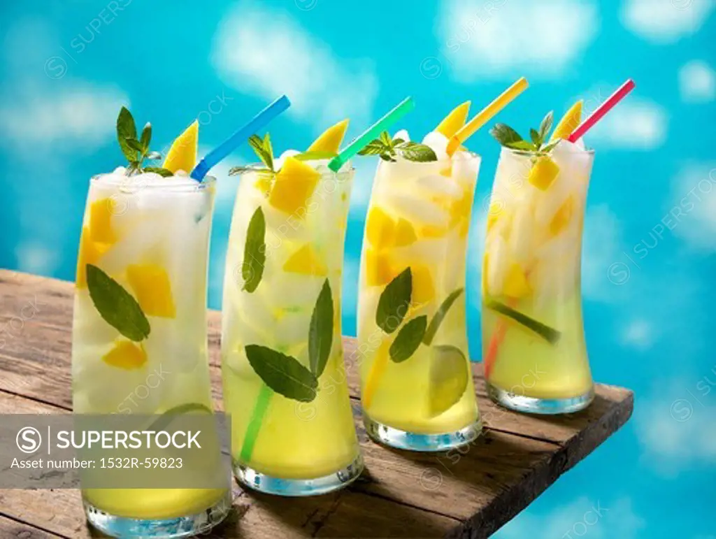 Four Mango Lime Mojitos with Straws on a Table