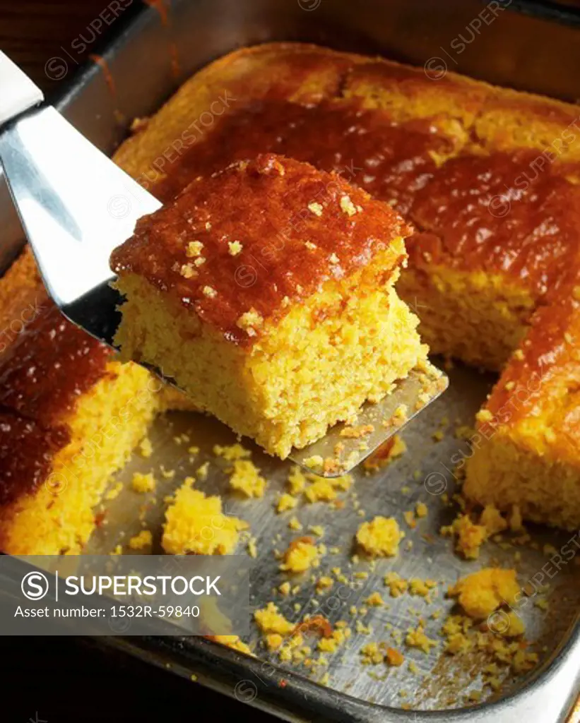 Removing a Piece of Cornbread from the Pan with a Spatula