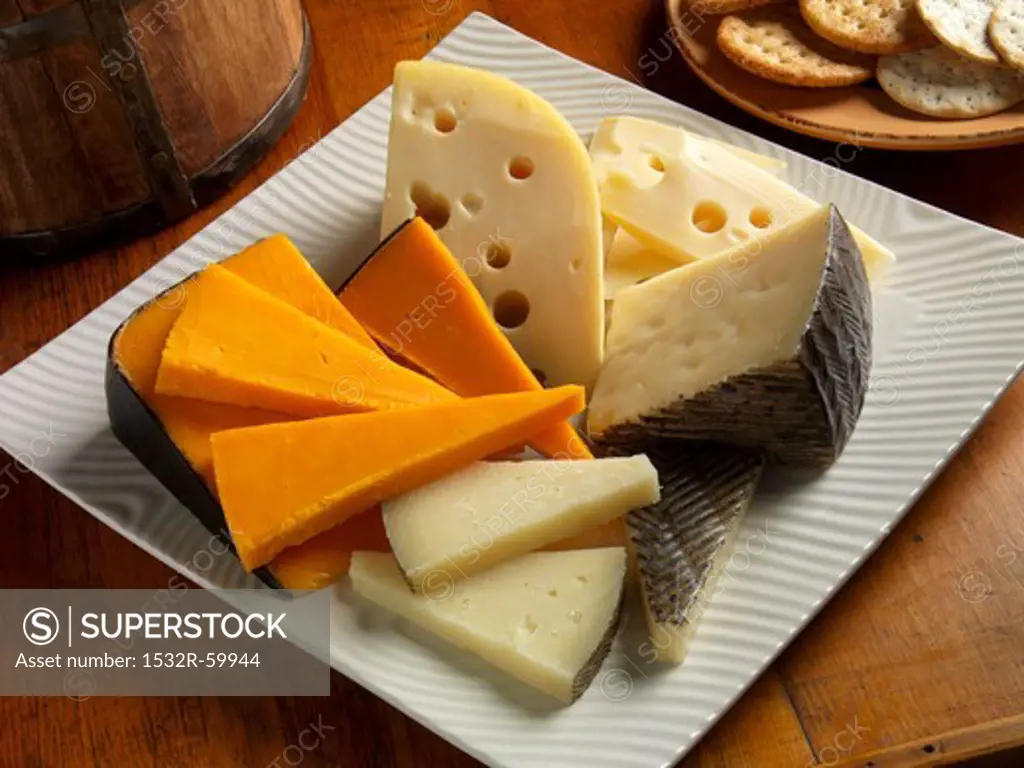 Cheddar, Baby Swiss and Manchego Cheese on a Plate; Crackers
