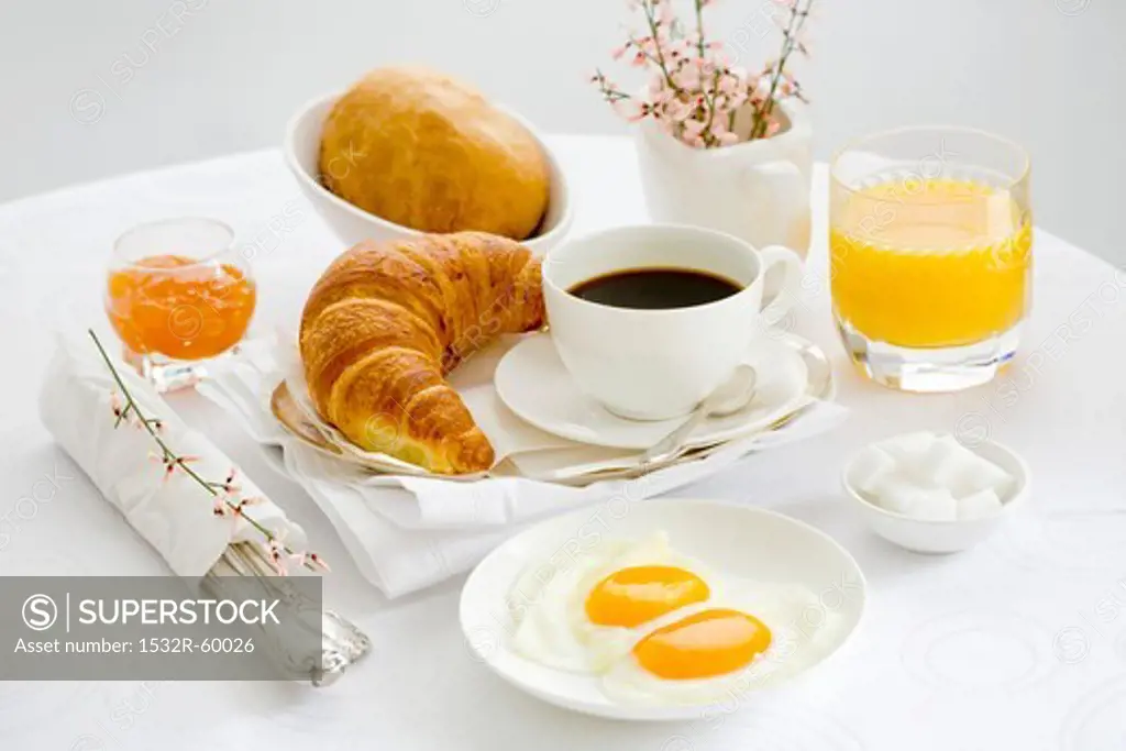 Breakfast with coffee, fried egg, orange juice and jam