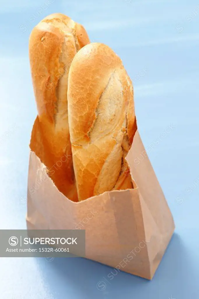 Two baguettes in a paper bag