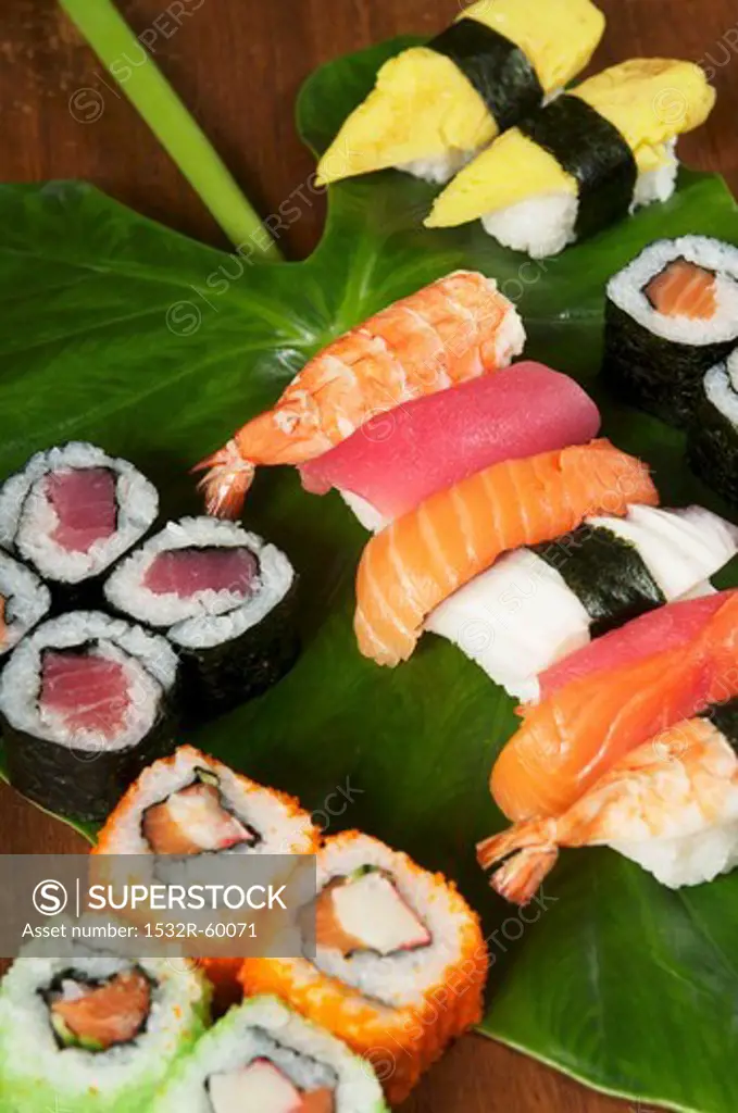 Various types of sushi on a leaf