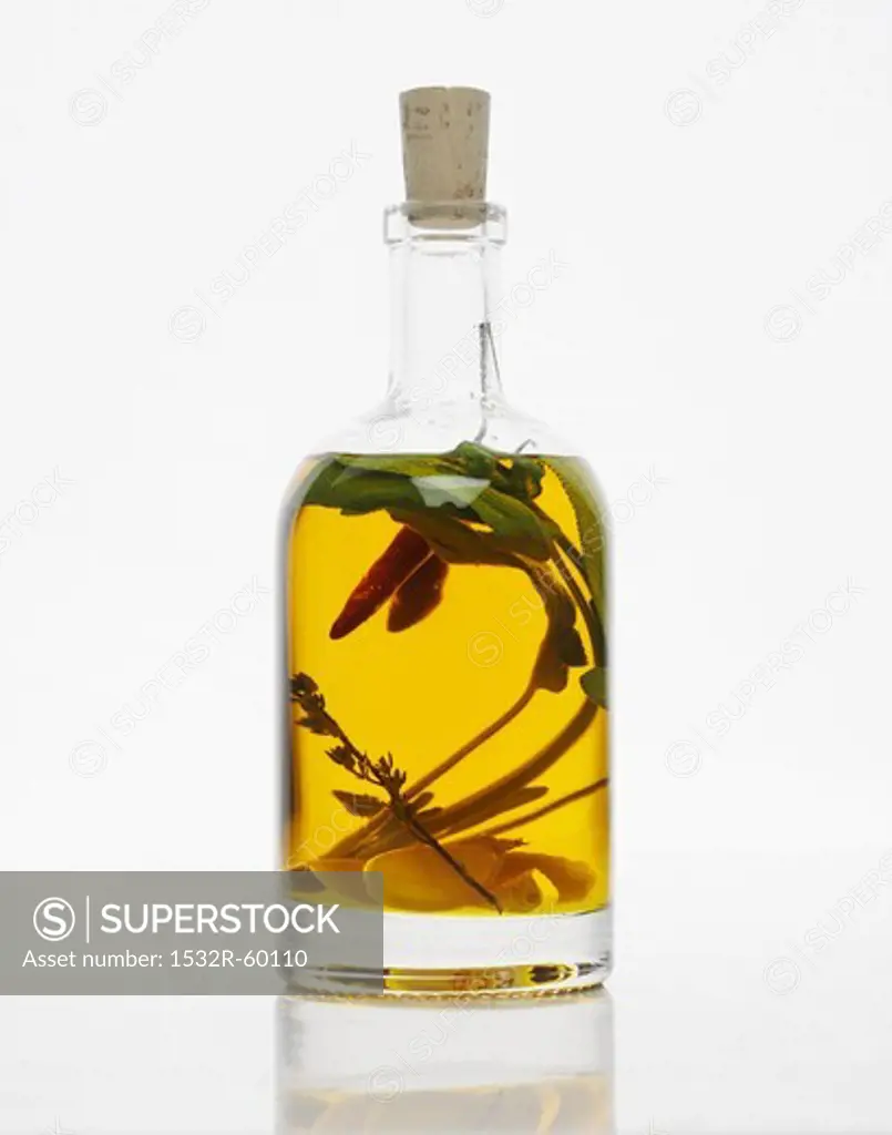 A bottle of herb oil with garlic and chillis