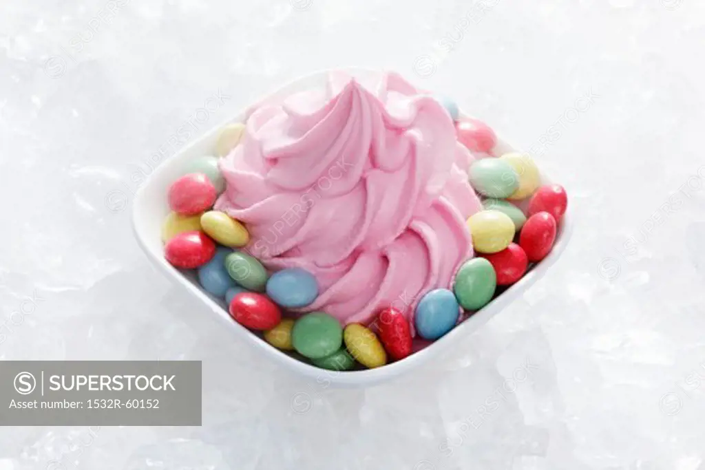 Strawberry yogurt ice cream with colourful chocolate beans