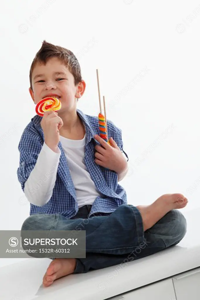 A little boy eating a lolly