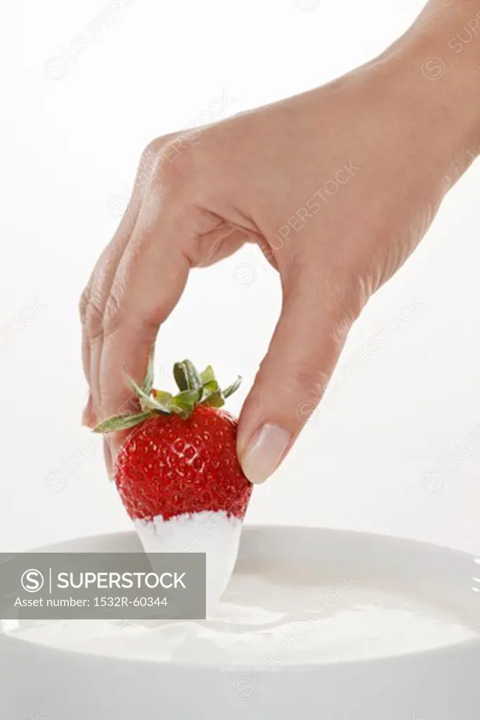 Hand dipped strawberries in organic yogurt