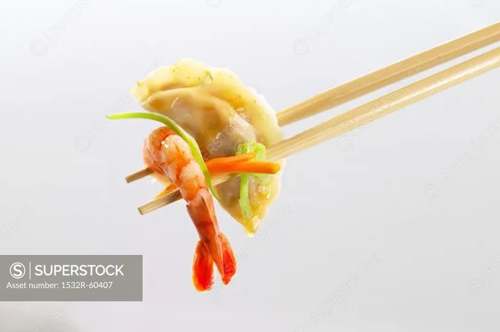 Wonton and shrimp on chopsticks (Asia)