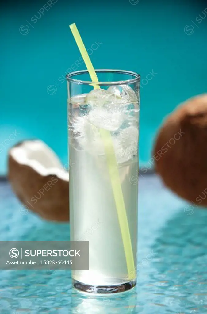 Glass of Coconut Water with Ice and a Straw