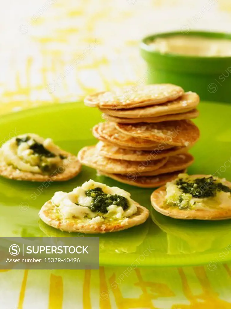 Sesame crackers with spread with soft cheese and pesto
