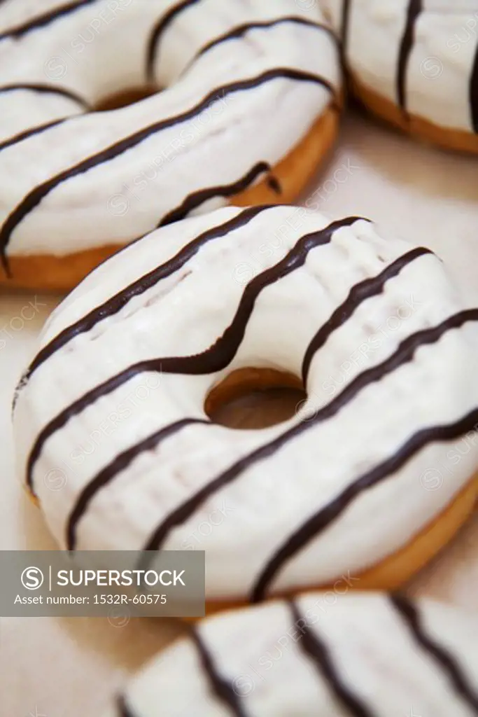 Iced donuts with chocolate stripes