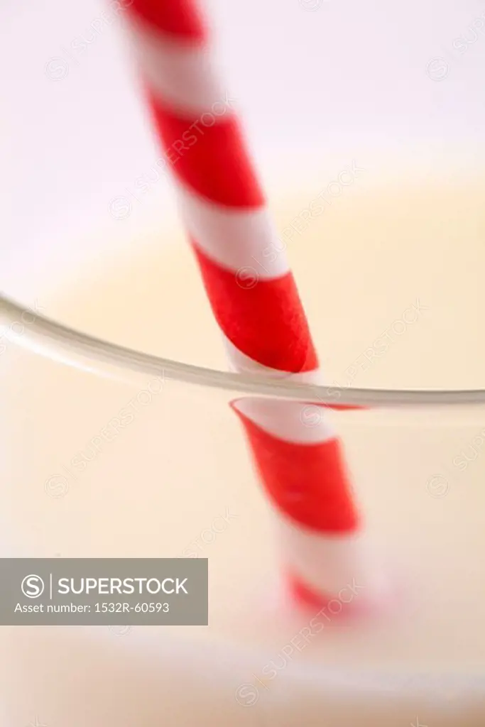 Glass of milk with a straw