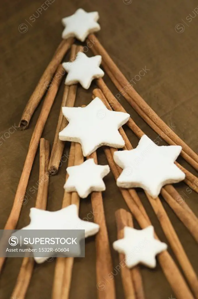 Cinnamon sticks forming the shape of a Christmas tree with cinnamon stars on top