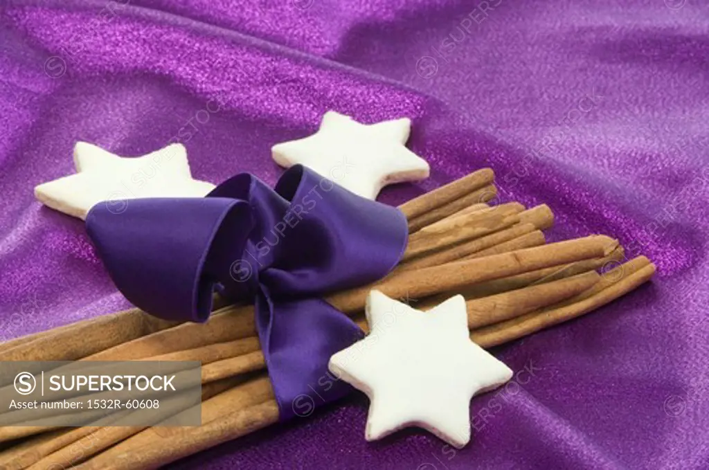 Cinnamon stars with cinnamon sticks wrapped with purple ribbon