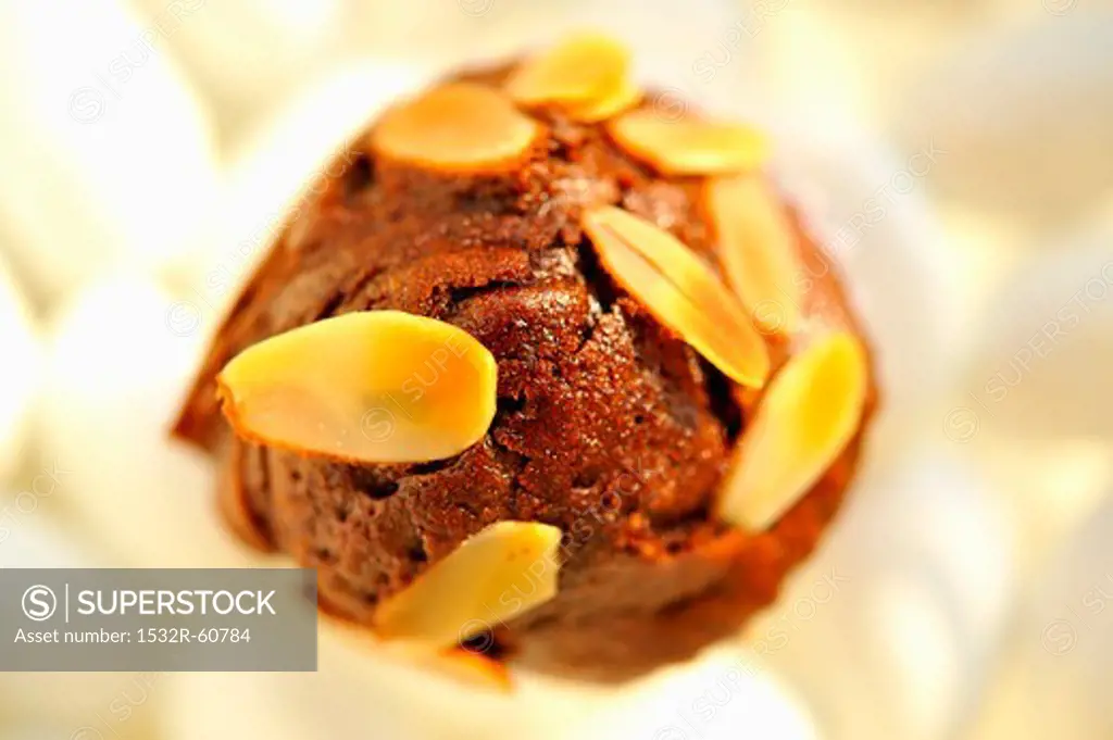 A brownie muffin with slivered almonds