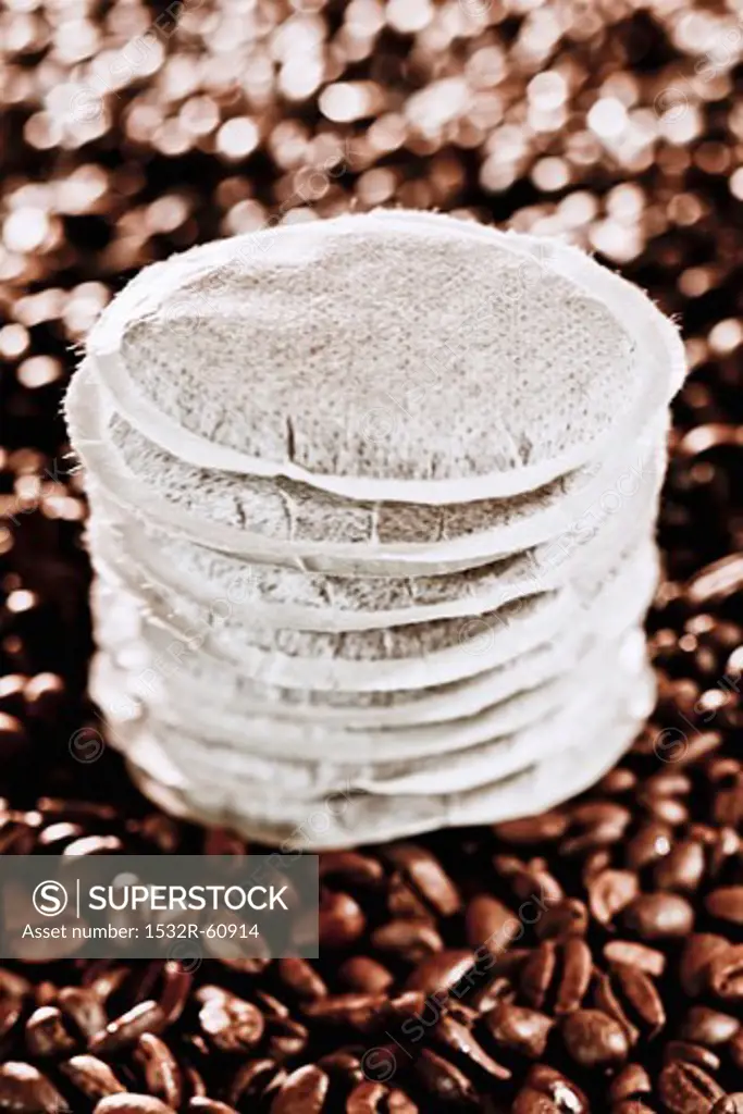 A stack of coffee pads on coffee beans