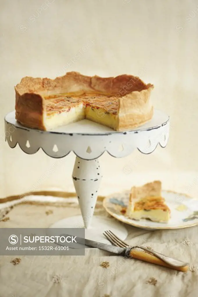 Sundried Tomato Quiche on a White Cake Stand; Slice Removed