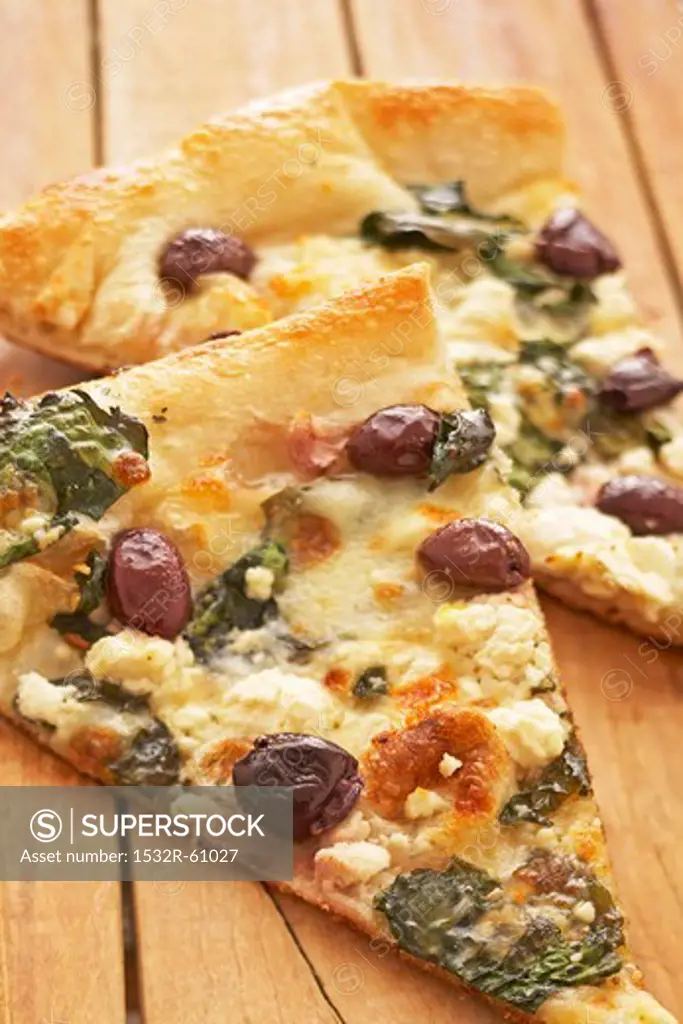 Two Slices of Greek Style Pizza with Kalamata Olives, Feta Cheese and Spinach