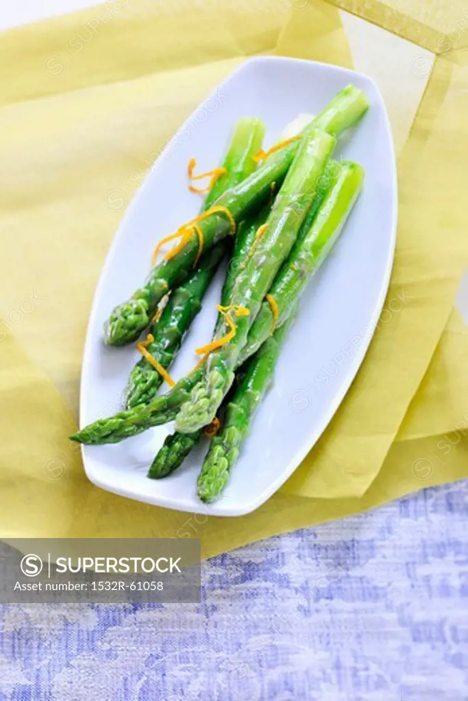 A green asparagus with orange zest