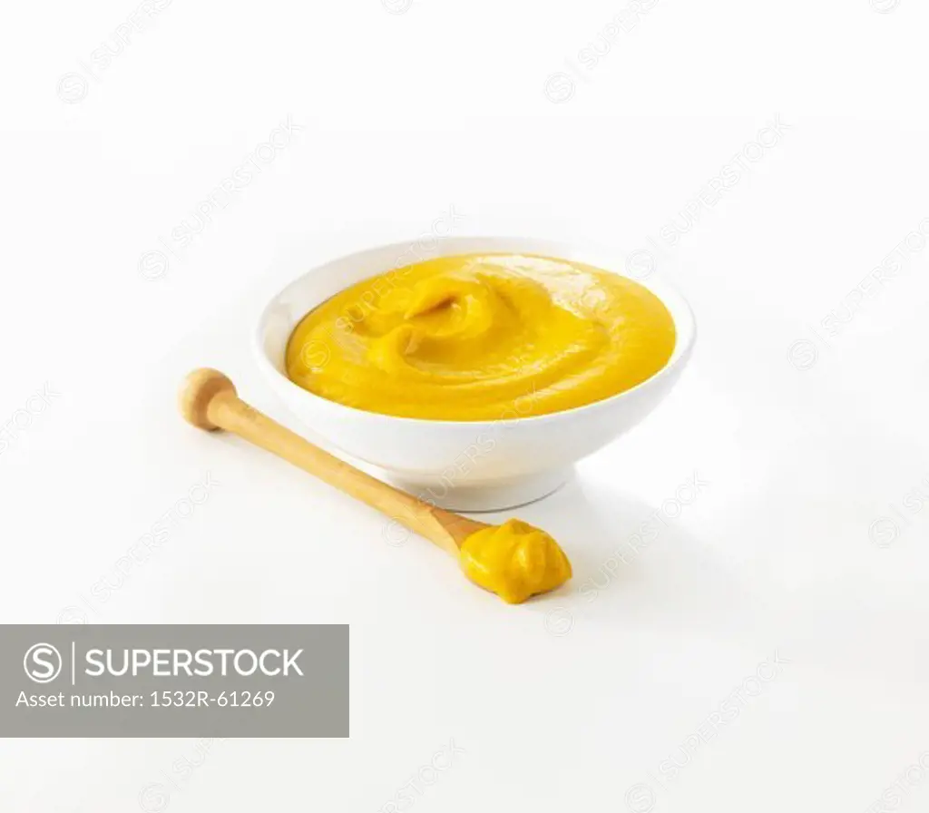 Mustard in small pot and on spoon