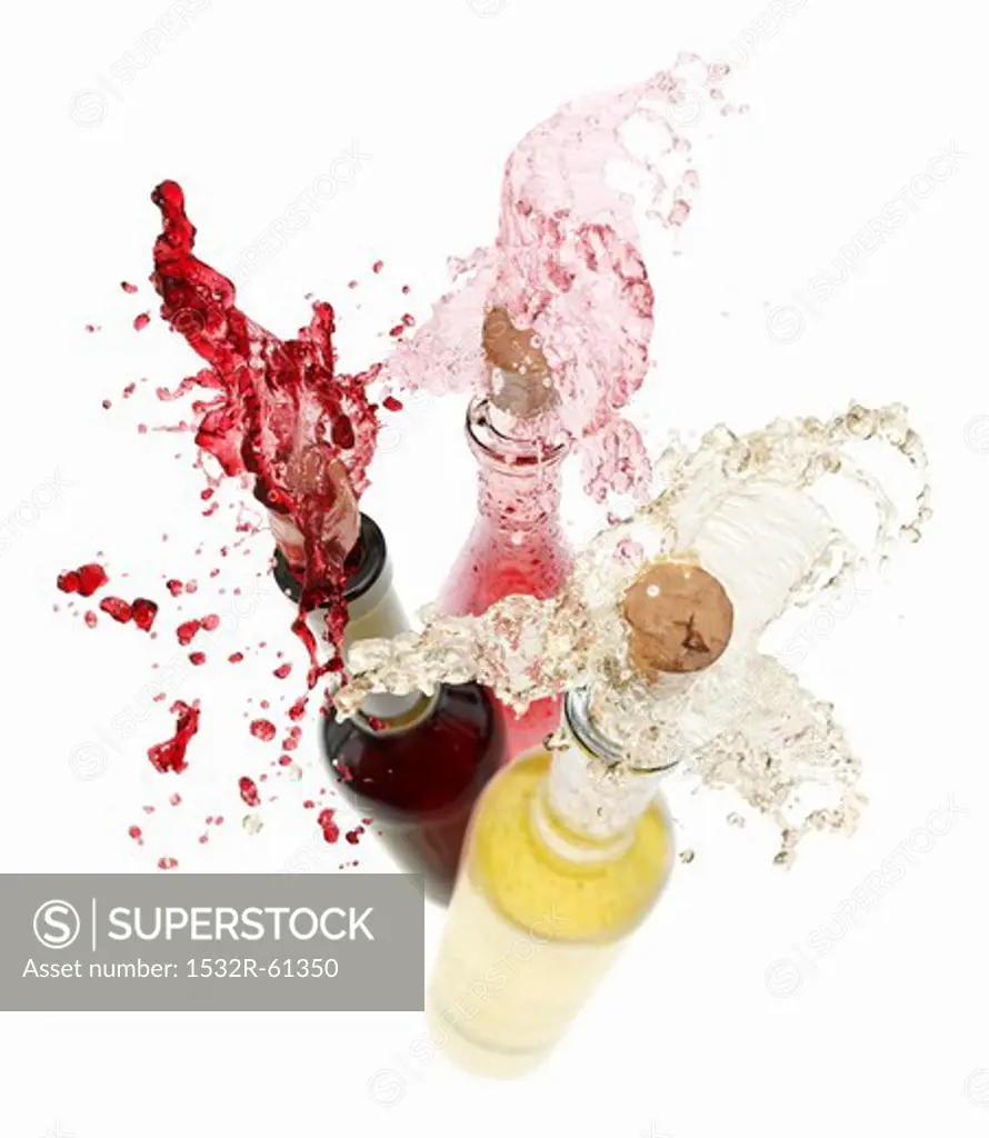 Wine spraying out of bottles (red wine, rose wine and white wine)
