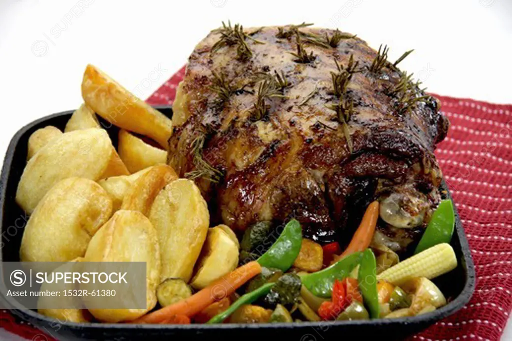 Roasted leg of lamb with rosemary, potatoes and vegetables