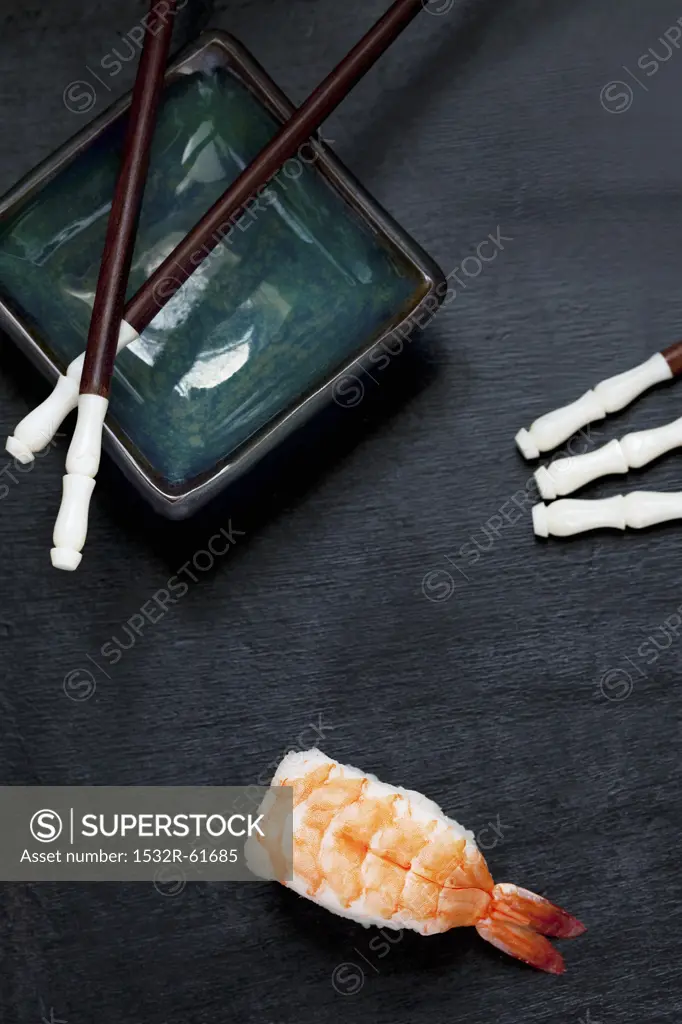A Piece of Shrimp Sushi; Bowl and Chopsticks