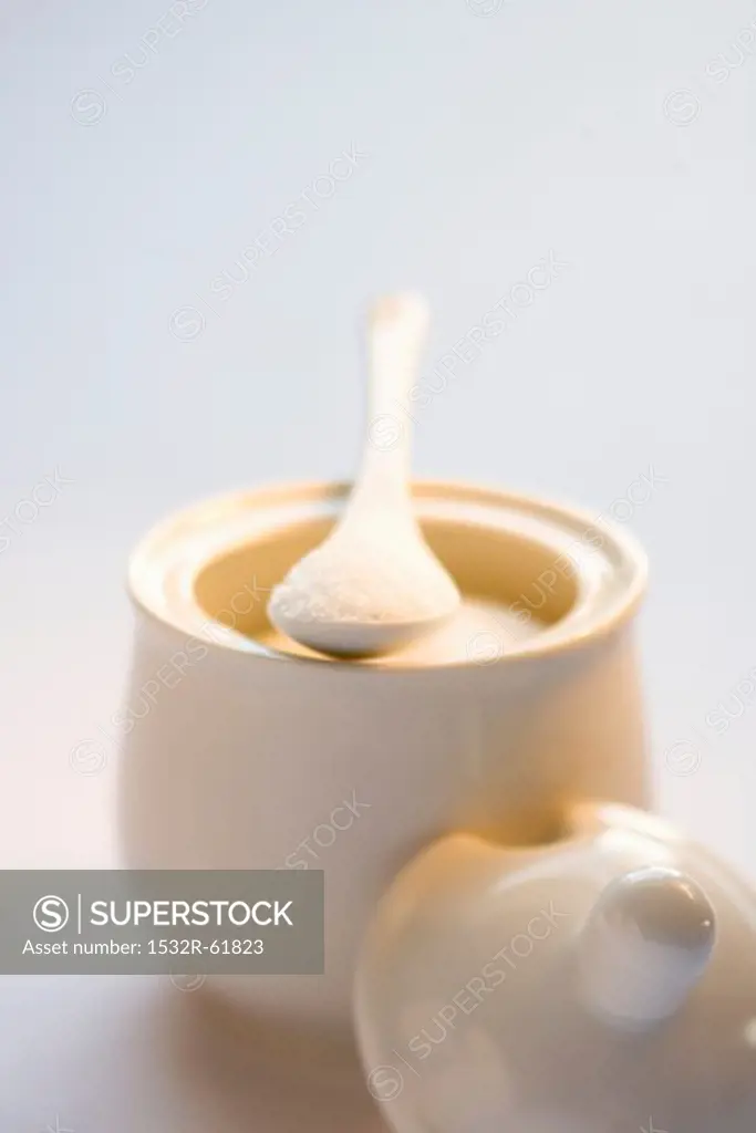 A sugar pot with a spoon