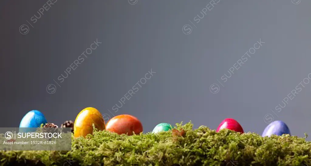 Colourful Easter eggs on moss