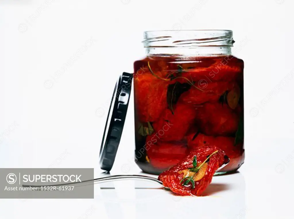 A jar of dried tomatoes in oil